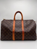 LOUIS VUITTON KEEPALL 45. Designer handbag with monogram pattern on a light gray background