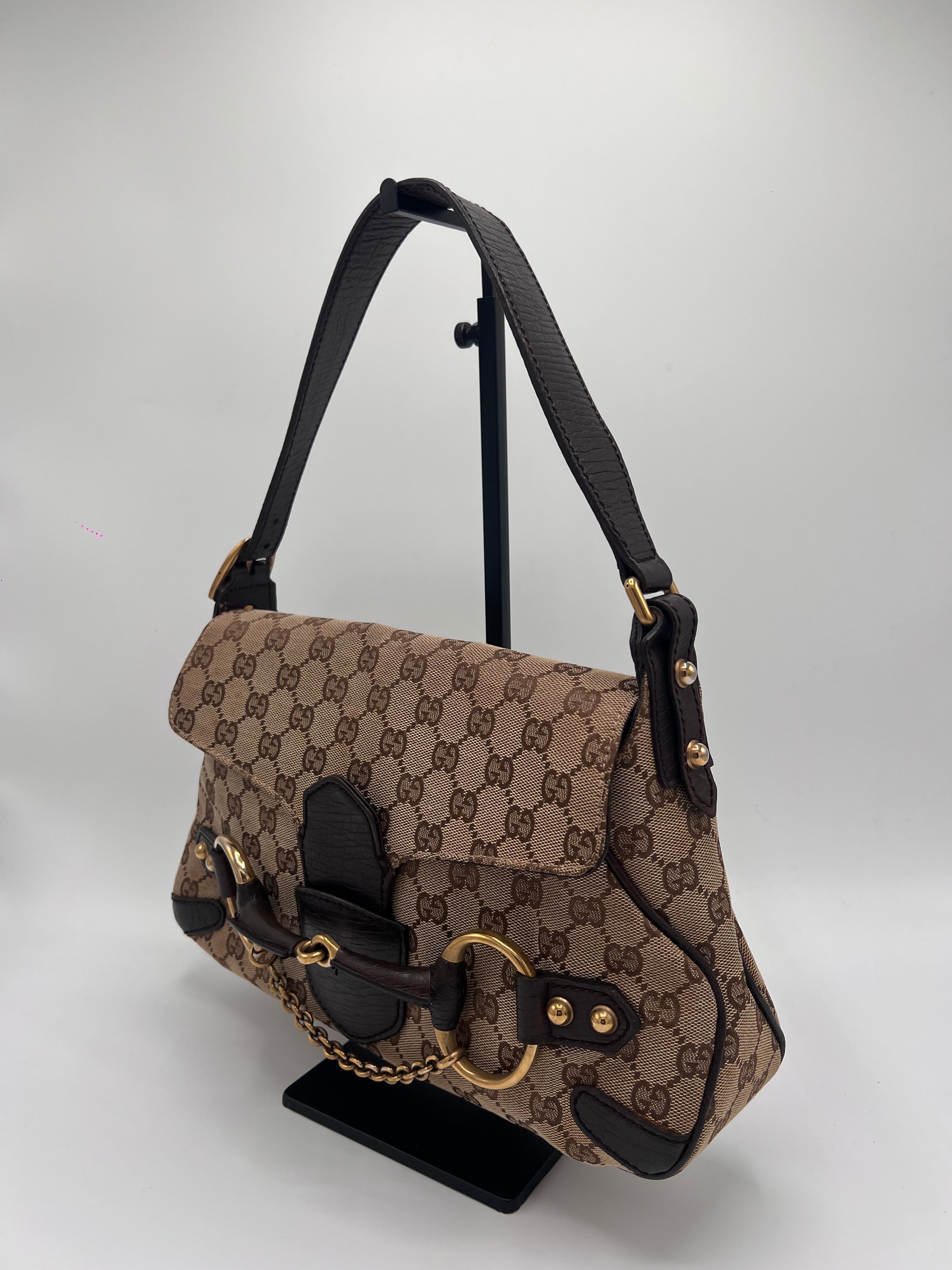 Brown patterned backpack with black straps on a light gray background