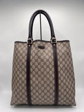 Gucci canvas patterned totebag with brown accents on a light gray background