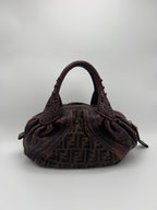 FENDI ZUCCA SPY. Brown textured handbag with a logo on a light gray background