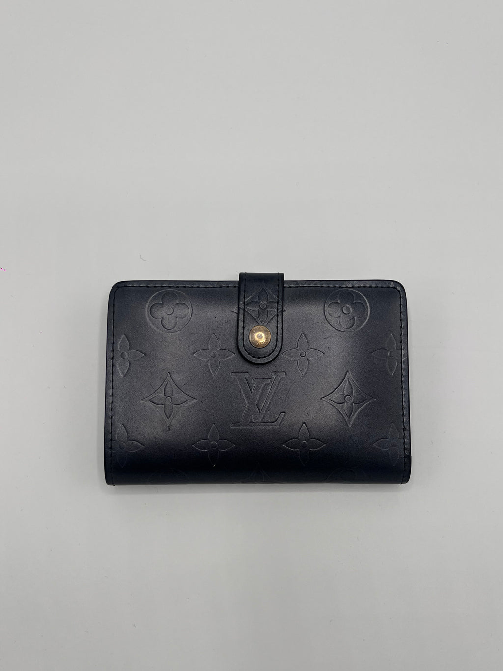 Dark blue Louis Vuitton leather wallet with brand logo on a gray background