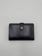 Dark blue Louis Vuitton leather wallet with brand logo on a gray background