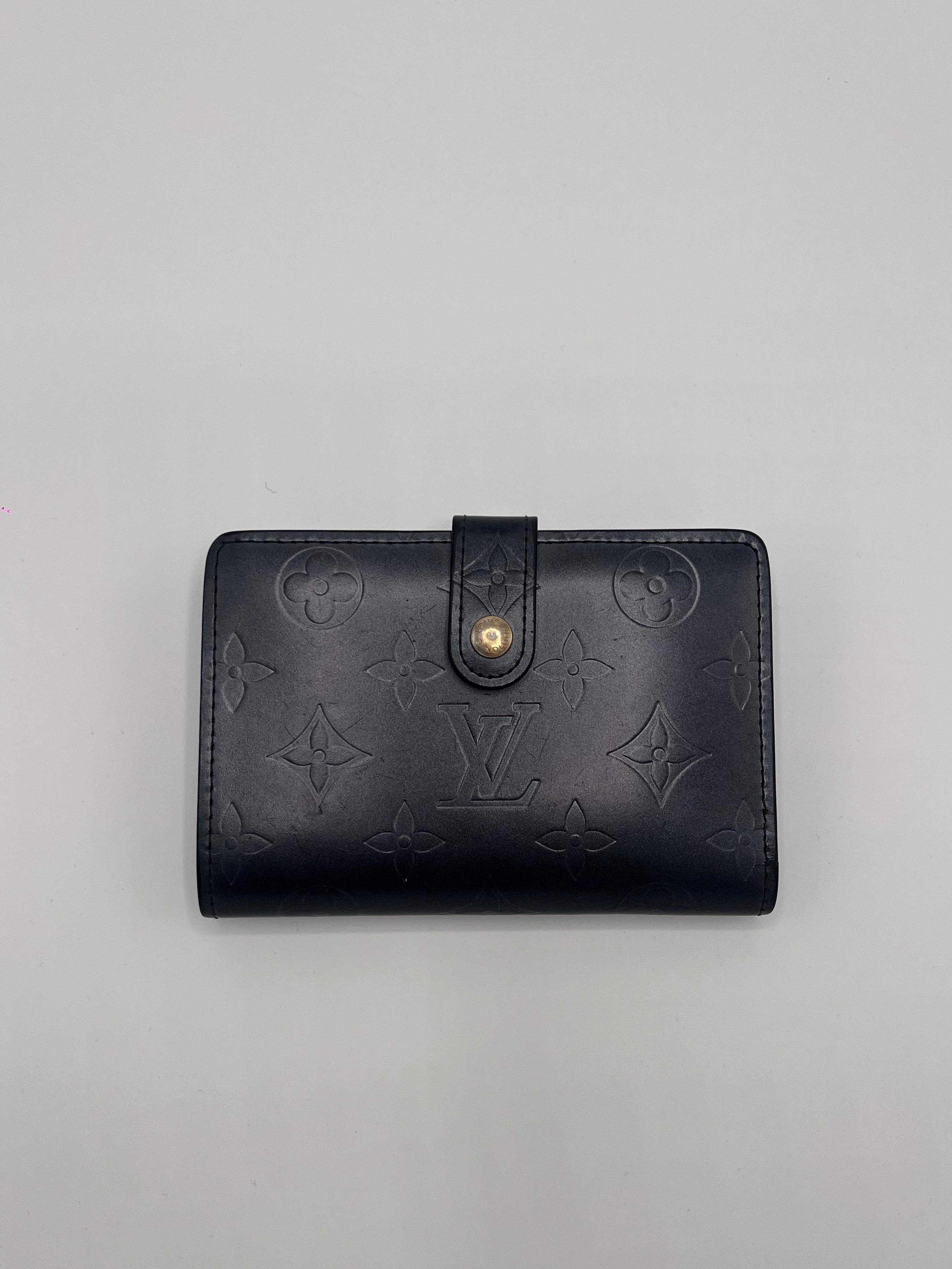 Dark blue Louis Vuitton leather wallet with brand logo on a gray background